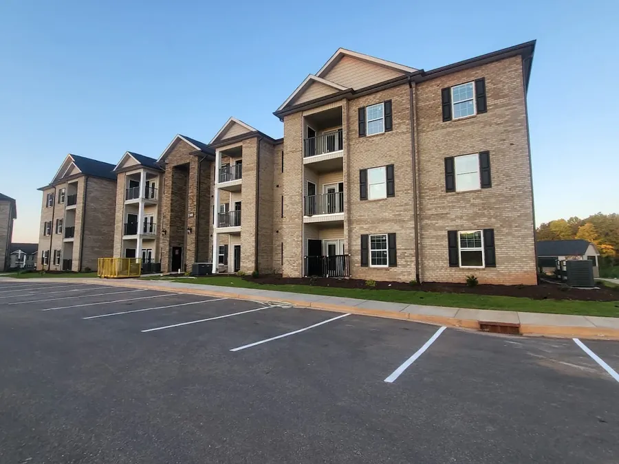 Three-story brick apartment community buildings with breezeways and balconies in the Upstate